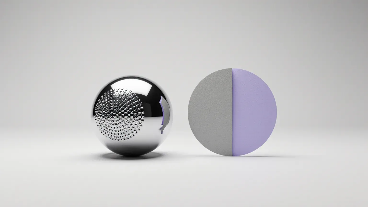 A chrome sphere covered in repeated tiny shapes beside a hand-cut paper disc, half grey and half violet