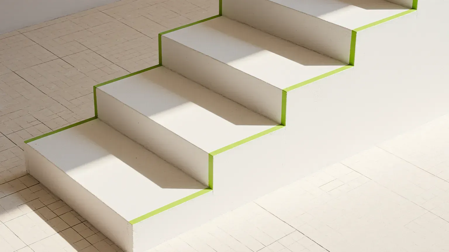 White plaster steps rising on a light grid floor, edged in lime, standing for SEO price tiers
