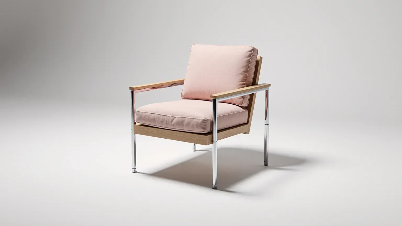 A made-to-measure oak and chrome armchair with pink cushions in a bright studio